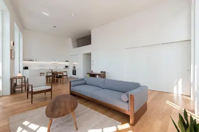 a living room with a blue couch and a table at Tripas-Coração, Santa Catarina in Porto