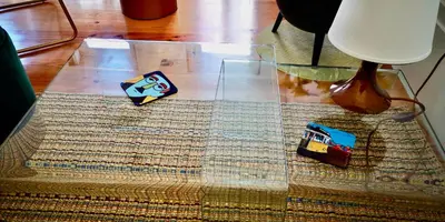 a glass table with a toy car on top of a rug at Appartement Pont Luiz in Porto