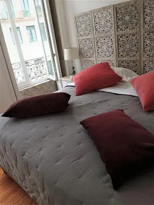 a large bed with red pillows in a bedroom at Appartement Pont Luiz in Porto