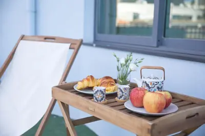 a table with two plates of bread and apples on it at Estúdio Corujeira in Porto