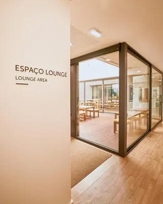 a patio with tables and chairs and umbrellas at BFRESH Hotel - Padel, Pool & Fitness - Adults Only in Porto