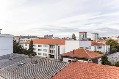 a city with white buildings and red roofs at 2BR Flat in Bonfim w/ AC & Balcony by LovelyStay in Porto