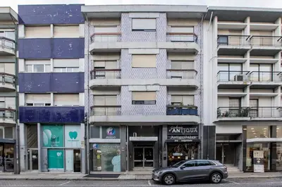 a car parked in front of an apartment building at 2BR Flat in Bonfim w/ AC & Balcony by LovelyStay in Porto
