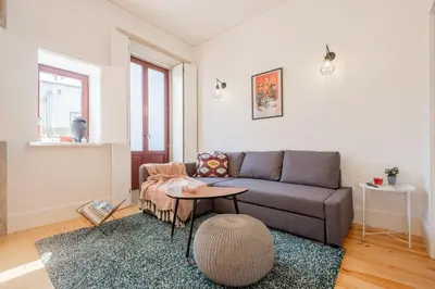a living room with a couch and a table at Oporto Shine in Porto
