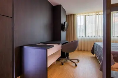 a room with a desk and a bed and a deskicterictericterswersswers at 406 Galé Center Apartment wifi, parking in Porto