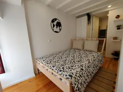 a bedroom with a bed in a room at Cais de Gaia Historic Loft in Vila Nova de Gaia