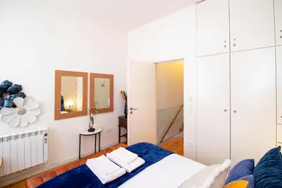 a room with a bed and a mirror at Luxurious Townhome with River View by LovelyStay in Porto