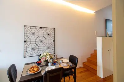 a dining room with a table with food on it at Luxurious Townhome with River View by LovelyStay in Porto