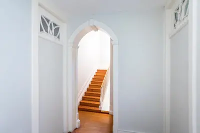 a hallway with an archway and stairs in a house at Bonjardim Studio w/ Balcony by LovelyStay in Porto