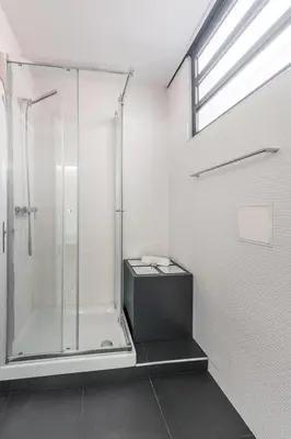 a bathroom with a shower with a glass shower stall at Papa 1T · Papa Studio Central Garden View in Porto