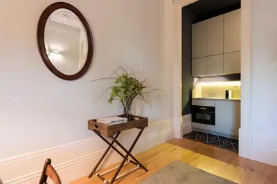 a living room with a mirror and a table at Habitat137 in Porto