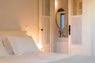 a bedroom with a white bed and a mirror at Habitat137 in Porto