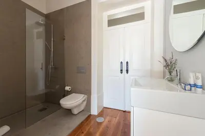 a bathroom with a toilet and a sink and a mirror at Habitat137 in Porto