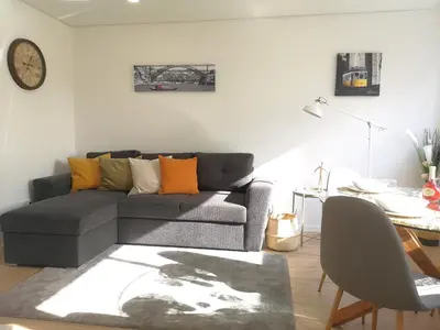 a living room with a couch and a table at OportoView Prestige Apartment in Porto