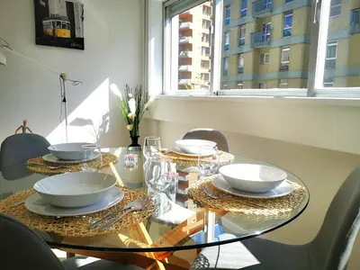 a dining room table with bowls and plates on it at OportoView Prestige Apartment in Porto
