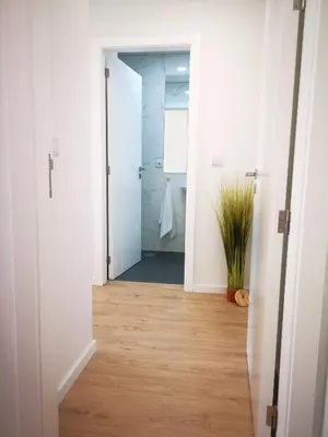 an open hallway with a door leading to a bathroom at OportoView Prestige Apartment in Porto