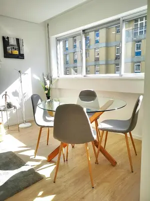 a dining room with a glass table and chairs at OportoView Prestige Apartment in Porto