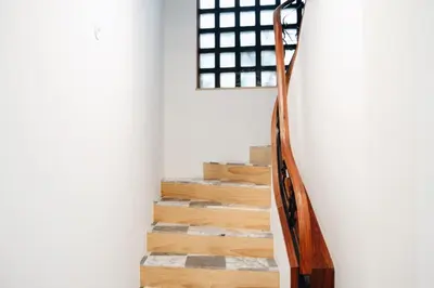 a staircase in a house with wooden railings at Oxford Green House by LovelyStay in Porto