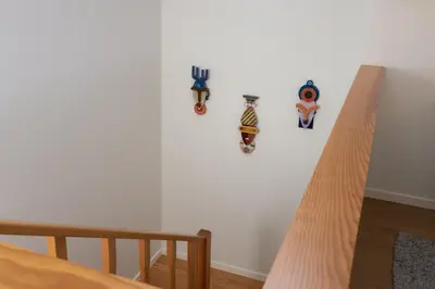 a wall with four toy figures on a wall at Box Market Square Apartment in Porto