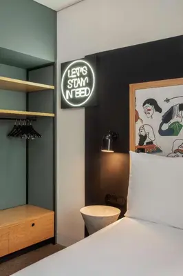 a bedroom with a bed and a sign on the wall at Se Catedral Hotel Porto, Tapestry Collection By Hilton in Porto