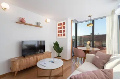 a living room with a television and a table at Habitatio - Bom Sucesso by LuxiStay in Porto