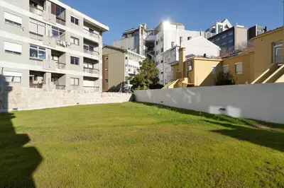 a grassy yard with buildings in the background at Habitatio - Bom Sucesso by LuxiStay in Porto