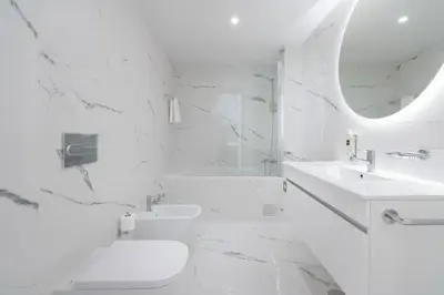 a white bathroom with a sink and a toilet at Habitatio - Bom Sucesso by LuxiStay in Porto