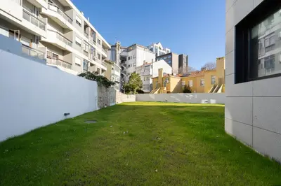 a grassy yard in the middle of a building at Habitatio - Bom Sucesso by LuxiStay in Porto