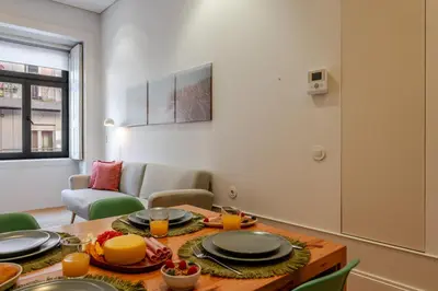 a living room with a table and a couch at Host Wise - Modern Stuning Flat w Prime Location in Porto
