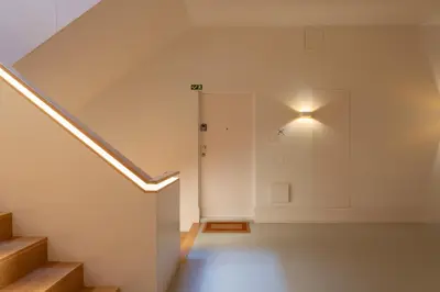 an attic hallway with stairs and a door at Host Wise - Modern Stuning Flat w Prime Location in Porto