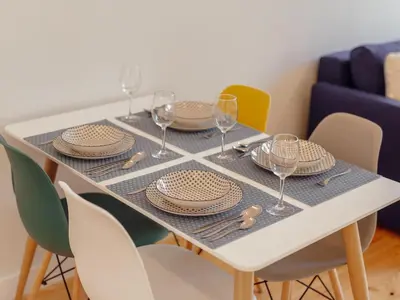 a dining table with plates and wine glasses on it at OPORTO GUEST Poveiros Home in Porto