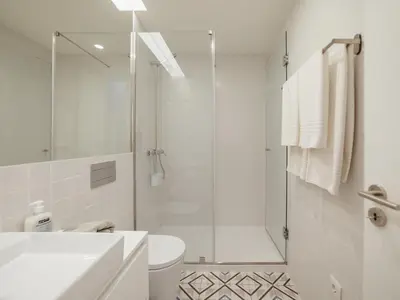 a white bathroom with a shower and a toilet at OPORTO GUEST Poveiros Home in Porto