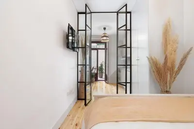 a bedroom with a bed and a mirror at Vibrant flat by São Bento w/balcony - Loureiro140 in Porto