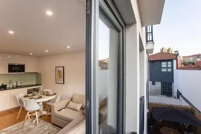 a view of a living room and kitchen from a balcony at City Center 2BR Flat w/ AC by LovelyStay in Porto