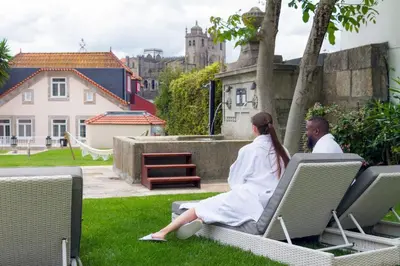 a man and a woman sitting on chairs in the grass at Oca Vitoria Village in Porto