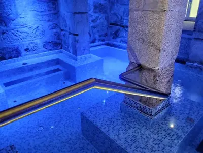 a pool of water next to a stone pillar at Oca Vitoria Village in Porto