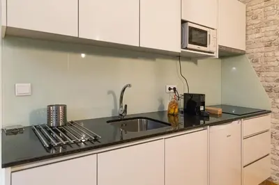 a kitchen with a sink and a microwave at Rolé Douro - Almada 340 in Porto