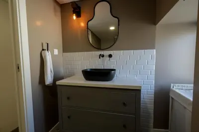 a bathroom with a toilet and a glass shower at Birds Apartments in Porto