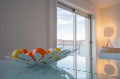 a bowl of fruit sitting on top of a glass table at North Star Flats @Santa Marinha in Vila Nova de Gaia