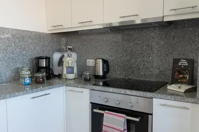 a kitchen with white cabinets and a counter top at North Star Flats @Santa Marinha in Vila Nova de Gaia