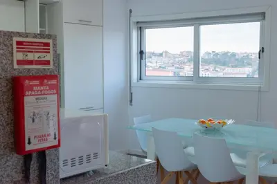 a dining room with a blue table and white chairs at North Star Flats @Santa Marinha in Vila Nova de Gaia