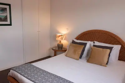 a bedroom with a white bed with pillows and a lamp at North Star Flats @Santa Marinha in Vila Nova de Gaia