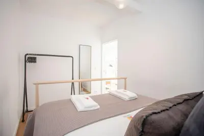 a bedroom with a bed with two towels on it at Liiiving in Porto - Ribeira Vintage View in Porto