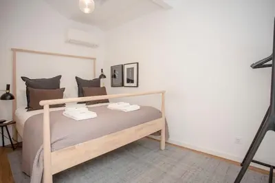 a bedroom with a wooden bed in a room at Liiiving in Porto - Ribeira Vintage View in Porto