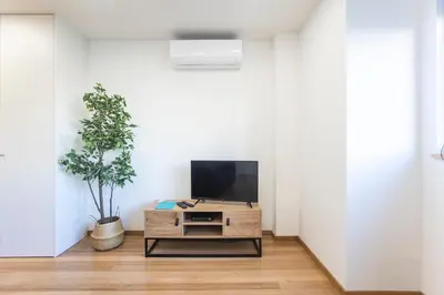 a living room with a tv on a table at Homely Studio w/ AC near Marquês by LovelyStay in Porto