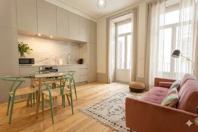 a living room with a couch and a table at Oporto City View- Trindade Lovely in Porto