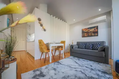a living room with a couch and a table at Sunshine Apartment in Porto
