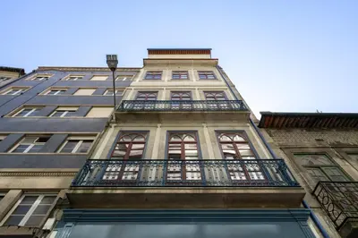a tall building with a balcony in front of it at Habitatio - Aliados by LuxiStay in Porto