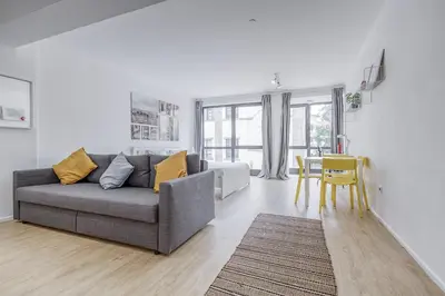 a living room with a gray couch and a table at Travel & Live Alegria Apartments in Porto