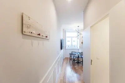 a hallway with a dining room and a table at Cute & Bright Flat w/ AC by LovelyStay in Porto